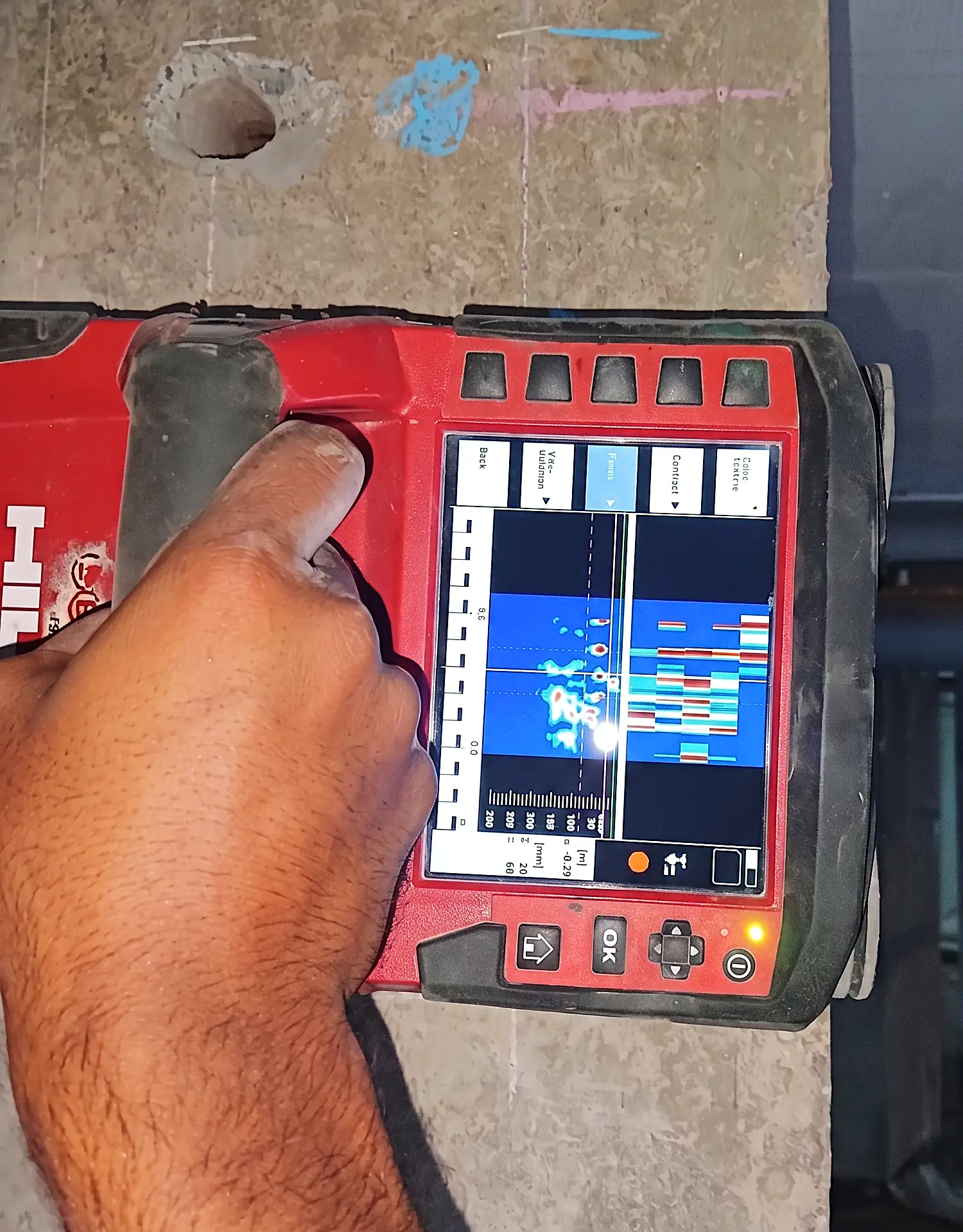 Scanning a column on site before drilling, reinforcement visible on the live display